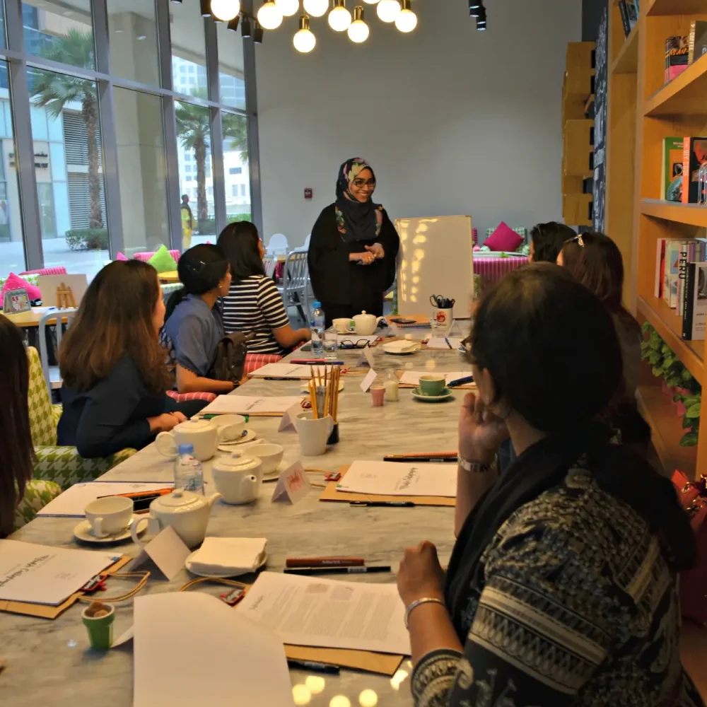 A women teaching calligraphy to students